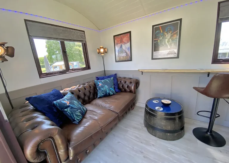 The Bar Sofa Seating Area and Barrel Table by Belringham Shepherd Huts