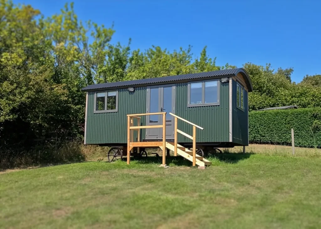 The Haven a corrugated metal hut painted in green by Belringham Shepherd Huts Cover