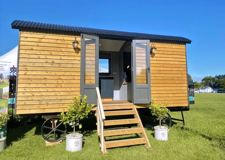 The Lookout hut covered in natural wood shiplap boards and steps by Belringham Shepherd Huts Cover
