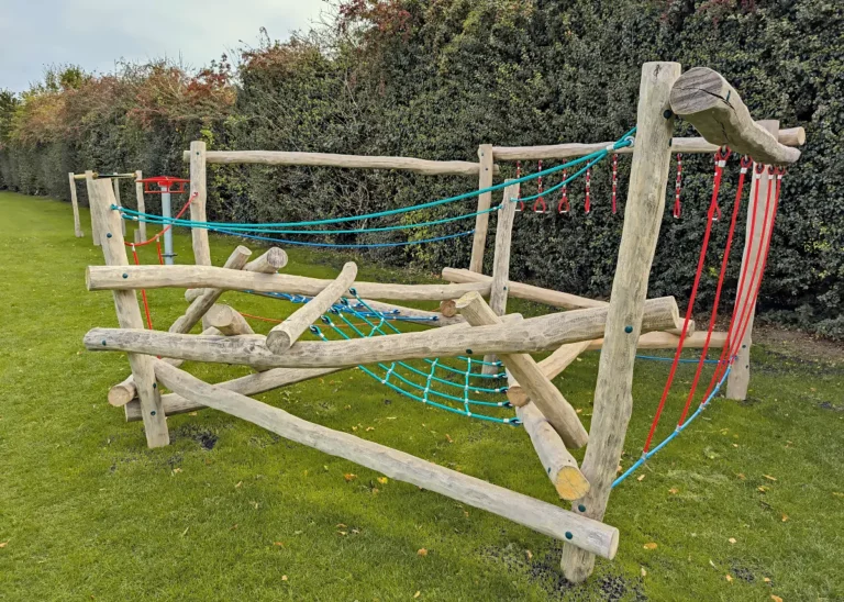 Playspaces Pole Climber Play Equipment in a Garden with hedge